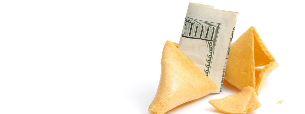 A broken fortune cookie with a folded hundred-dollar bill inside, yellow cookie and white bill on a white background